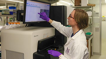 woman in lab loading sequencer